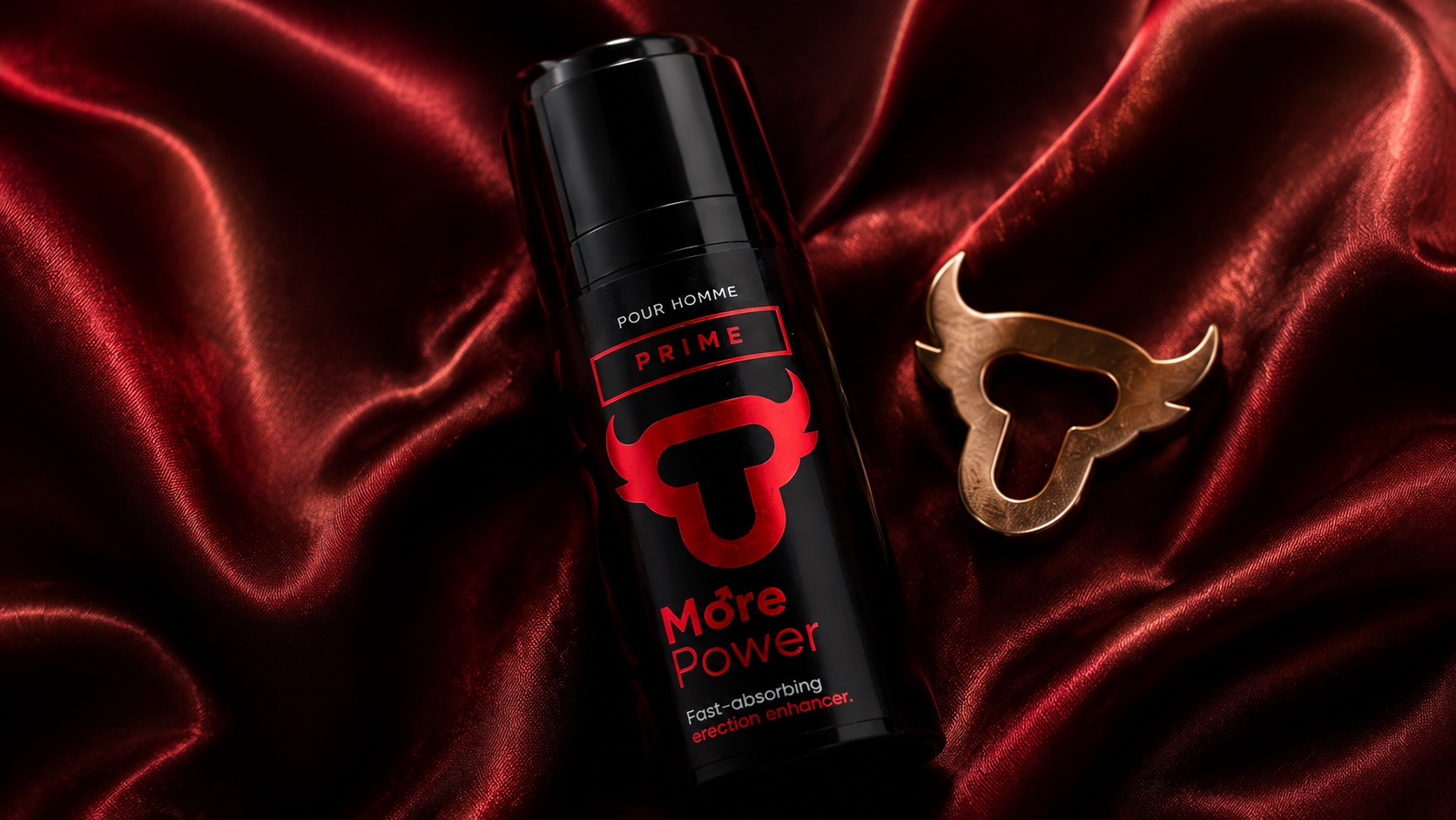 Prime airless bottle lying on deep red satin next to a golden bull pendant