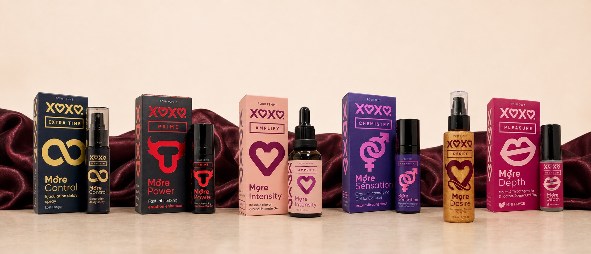 All six XOXO products lined up in front of burgundy satin
